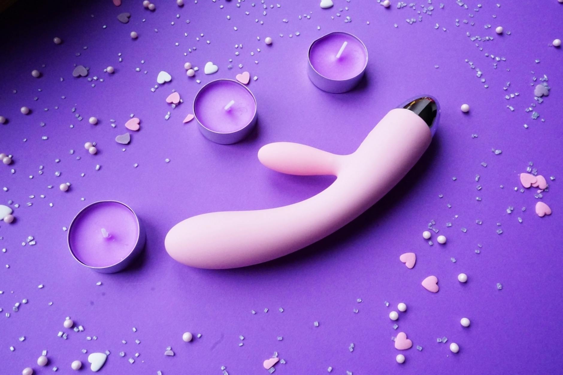Fresh lemon halves on a pink background in sunlight, symbolizing refreshed pleasure and renewal